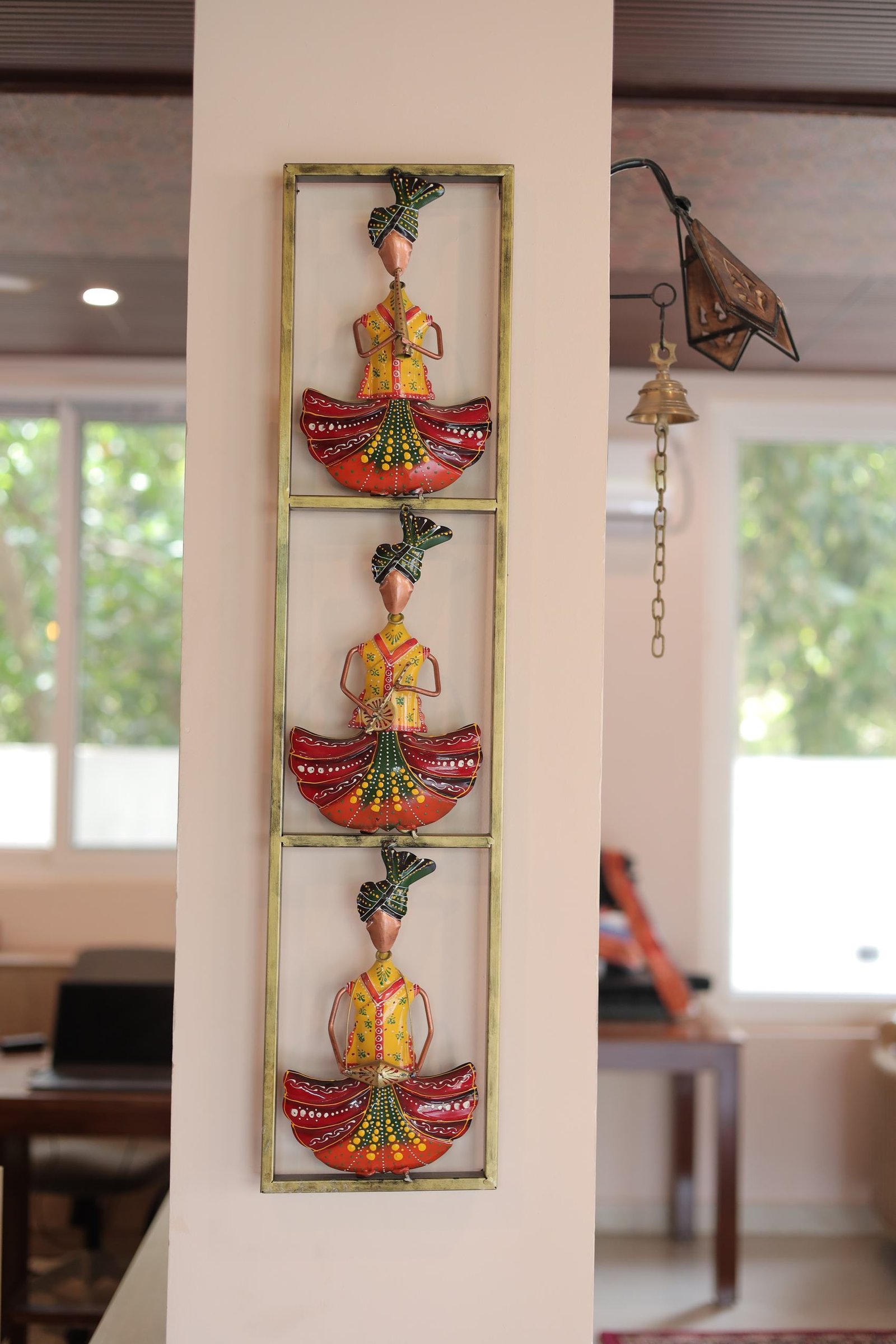 Painted metal figures framed on the pillar